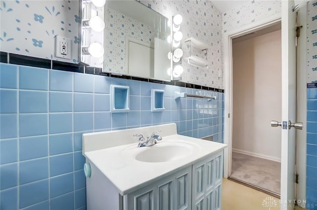 bathroom featuring vanity and tile walls