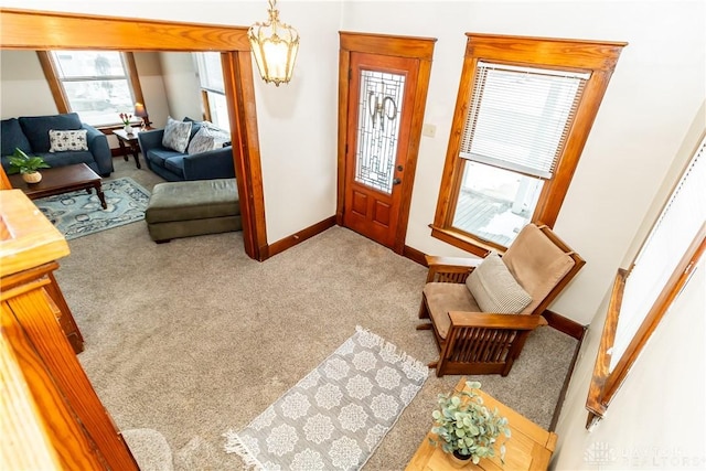 living room featuring carpet flooring and a chandelier