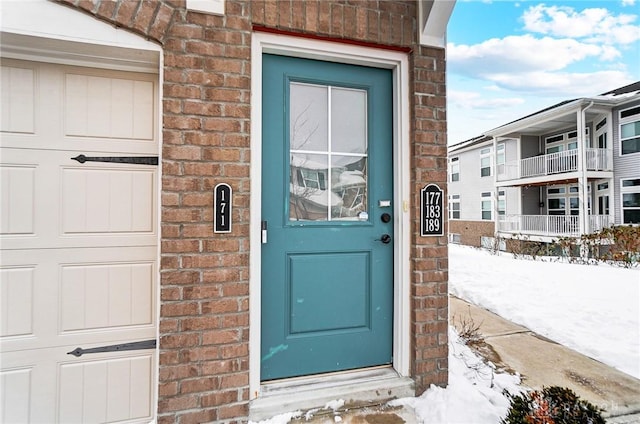 view of snow covered property entrance