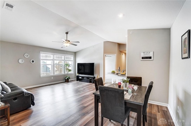 dining area featuring hardwood / wood-style floors, ceiling fan, and vaulted ceiling