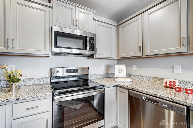 kitchen with light stone counters and stainless steel appliances