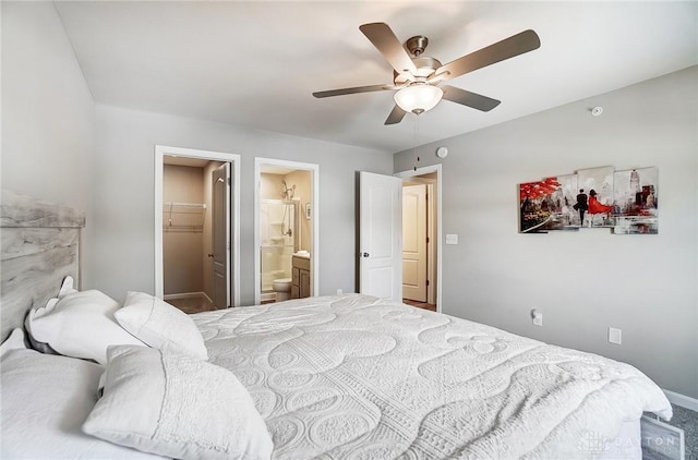 bedroom with ensuite bath, a spacious closet, a closet, and ceiling fan