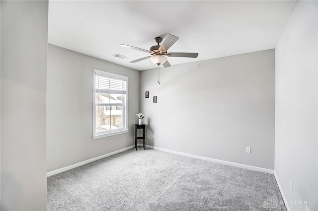 carpeted spare room with ceiling fan