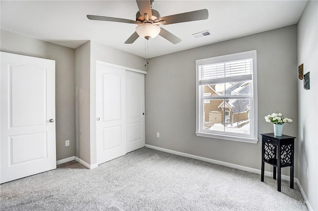 bedroom featuring ceiling fan, a closet, and light carpet