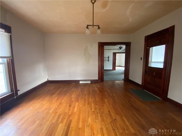 spare room featuring hardwood / wood-style flooring and ceiling fan