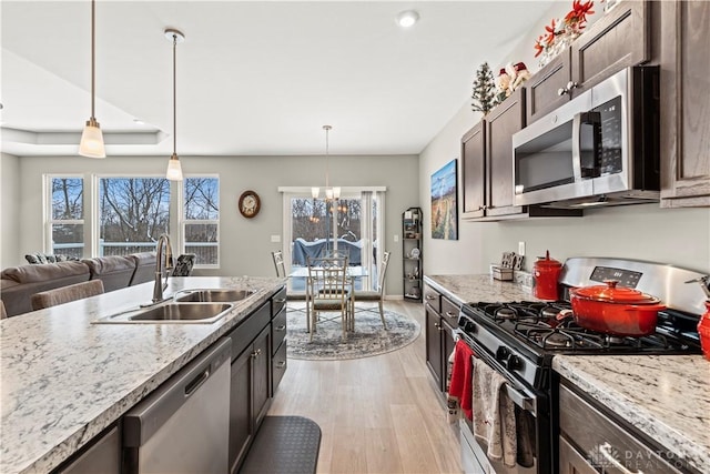 1189 Heathgate Way, Fairborn, OH 45324 - kitchen featuring a healthy amount of sunlight, stainless steel appliances, light wood-type flooring, and a sink