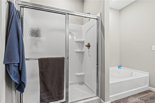 1189 Heathgate Way, Fairborn, OH 45324 - full bathroom featuring a bath, baseboards, wood finished floors, and a shower stall