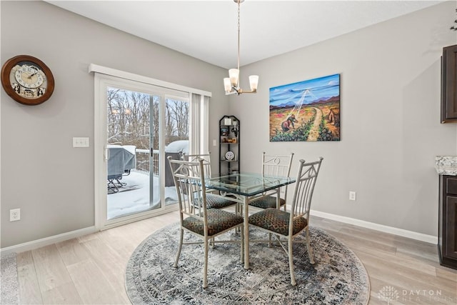 1189 Heathgate Way, Fairborn, OH 45324 - dining area with baseboards, light wood-style floors, and a chandelier