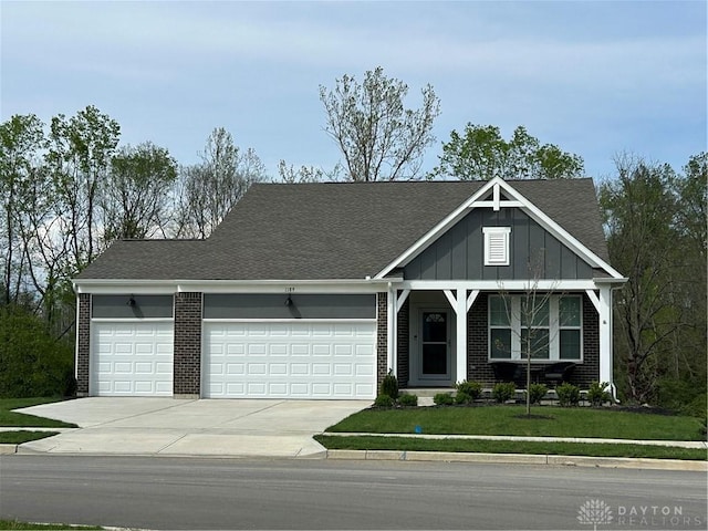 1189 Heathgate Way, Fairborn, OH 45324 - view of front of house with driveway, board and batten siding, brick siding, an attached garage, and a front lawn