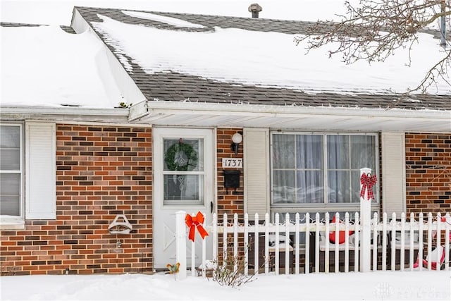 view of snow covered property entrance