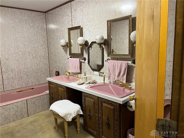 bathroom with vanity, ornamental molding, and tiled tub