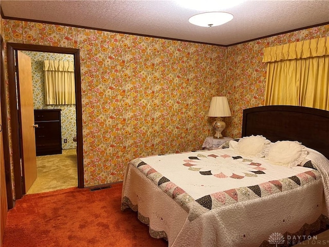 bedroom featuring carpet floors, a textured ceiling, and ornamental molding