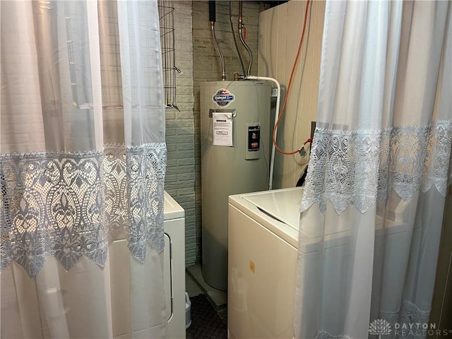 laundry room with independent washer and dryer and electric water heater