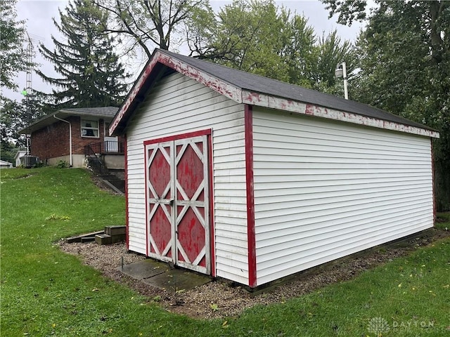 view of outbuilding with a lawn