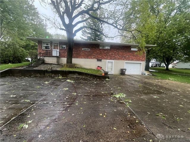 rear view of house featuring a garage