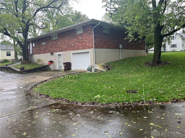 view of side of property with a lawn and a garage