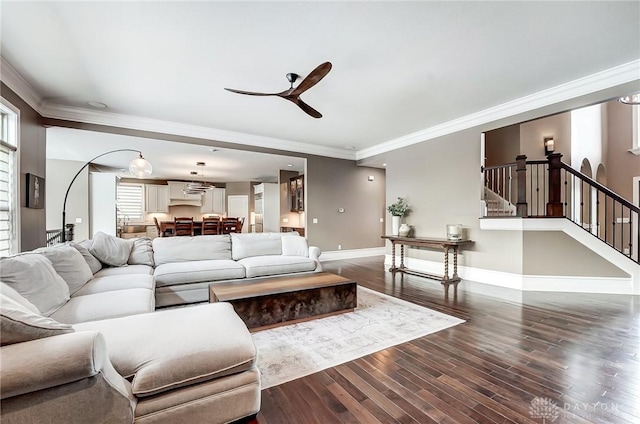 living room featuring hardwood / wood-style floors, ceiling fan, and crown molding