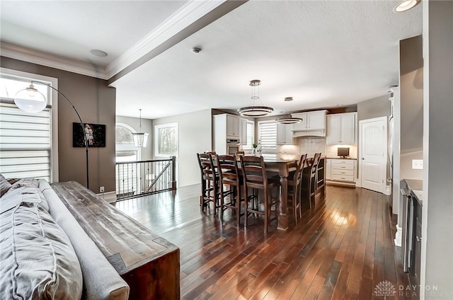 dining space featuring dark wood-type flooring and ornamental molding