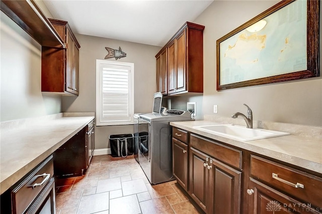 clothes washing area featuring cabinets, separate washer and dryer, sink, and light tile patterned floors