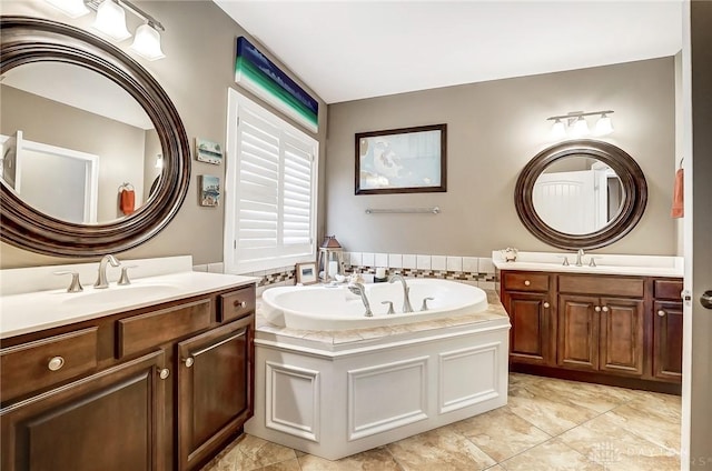 bathroom featuring tile patterned floors, vanity, and a bath