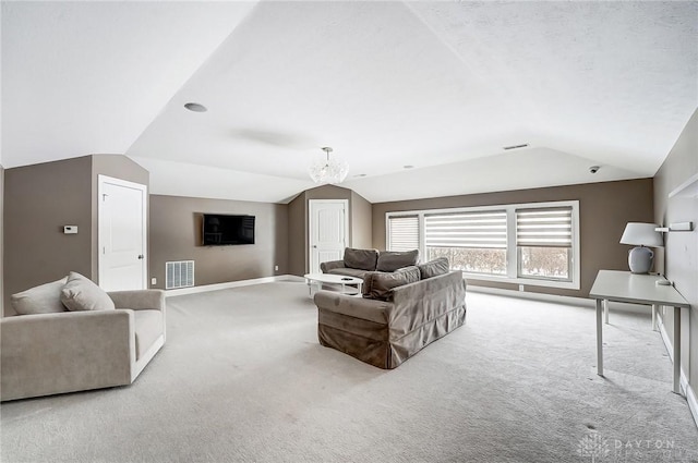 living room featuring light carpet, a chandelier, and vaulted ceiling