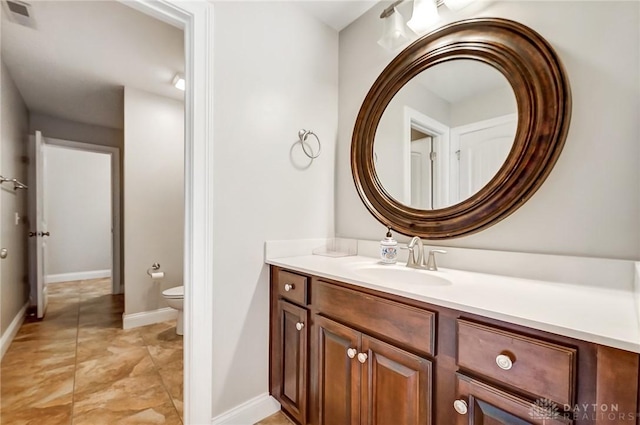 bathroom featuring vanity and toilet