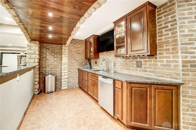 kitchen featuring stone counters, sink, stainless steel dishwasher, brick wall, and wood ceiling