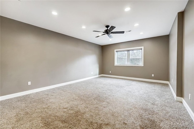 spare room featuring ceiling fan and carpet floors