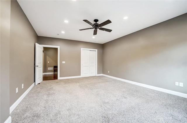 unfurnished bedroom featuring ceiling fan, carpet floors, and a closet