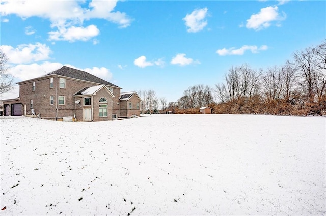 yard covered in snow with a garage