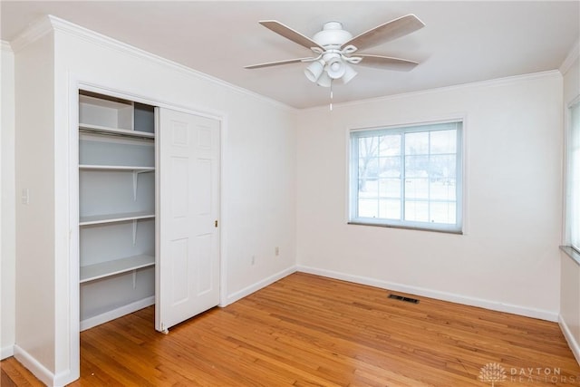 unfurnished bedroom featuring a closet, ceiling fan, light hardwood / wood-style flooring, and ornamental molding