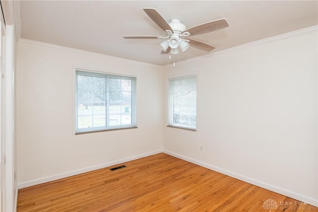 unfurnished room with light hardwood / wood-style floors, ceiling fan, and ornamental molding