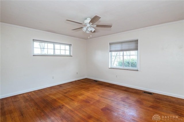 unfurnished room with wood-type flooring, plenty of natural light, and crown molding