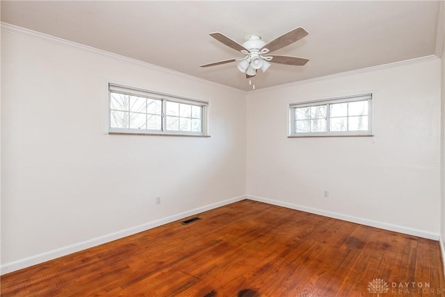 empty room with ceiling fan, wood-type flooring, and ornamental molding