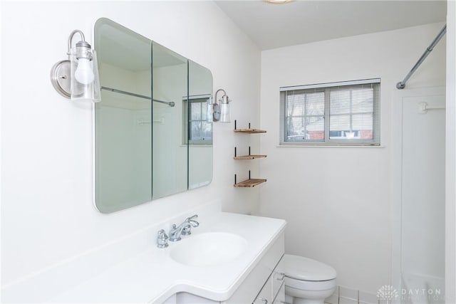 bathroom with walk in shower, vanity, and toilet