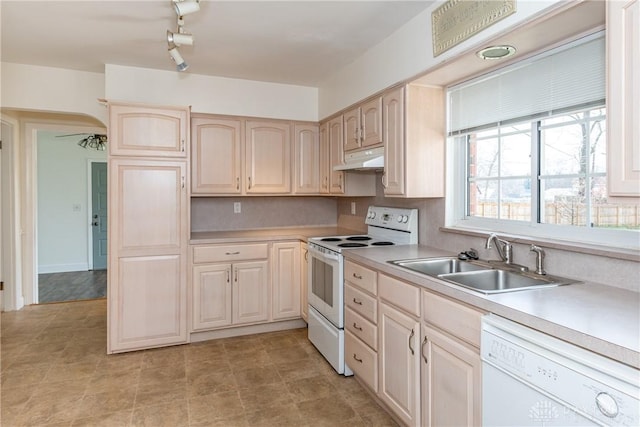 kitchen featuring backsplash, light brown cabinets, white appliances, and sink