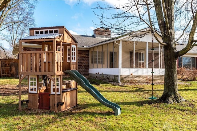 view of playground with a lawn