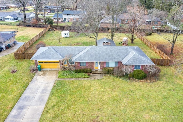 view of front of property featuring a front yard and a garage