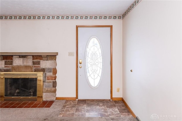 entrance foyer featuring a stone fireplace