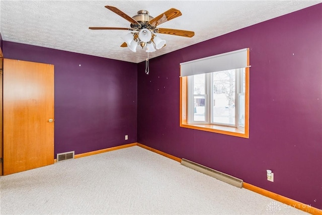 carpeted spare room featuring a textured ceiling, ceiling fan, and a baseboard heating unit