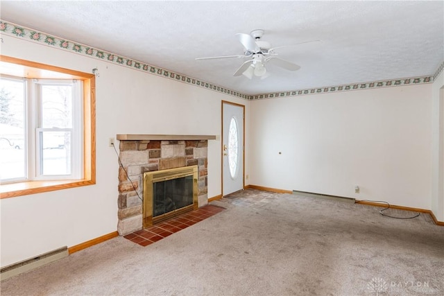 unfurnished living room with carpet, a textured ceiling, ceiling fan, a baseboard heating unit, and a fireplace