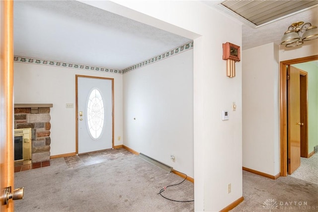 foyer featuring a stone fireplace and light colored carpet