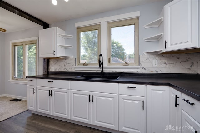 kitchen featuring a wealth of natural light, sink, and white cabinets