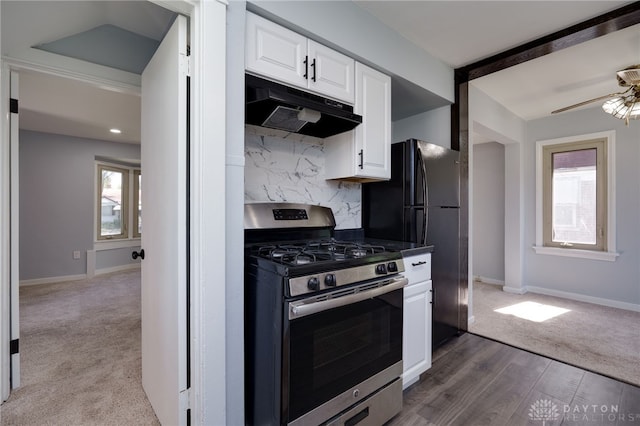 kitchen featuring white cabinets, dark colored carpet, plenty of natural light, and stainless steel range with gas stovetop