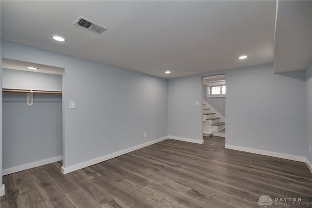 basement with dark hardwood / wood-style flooring