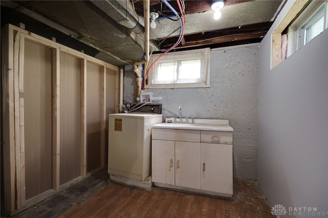 clothes washing area with cabinets, dark hardwood / wood-style floors, washer / dryer, and sink