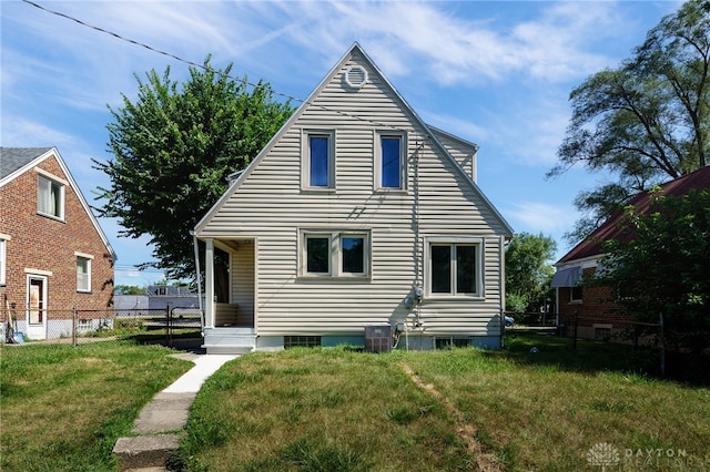 rear view of property featuring a yard