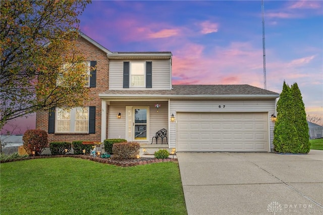 view of front property with a yard and a garage