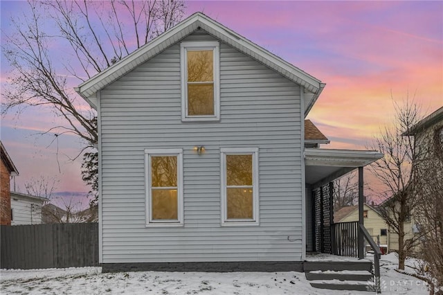 view of snow covered rear of property