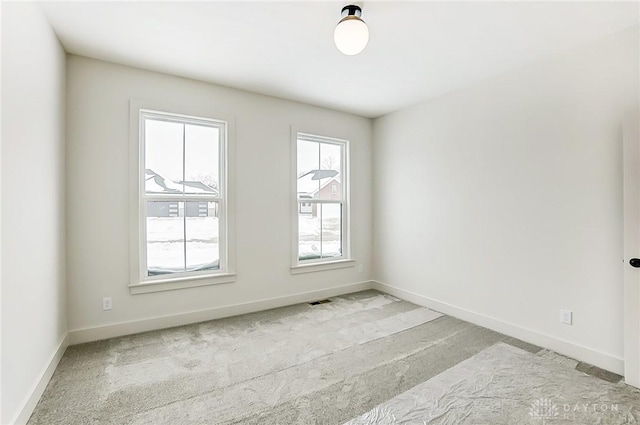 spare room with light colored carpet